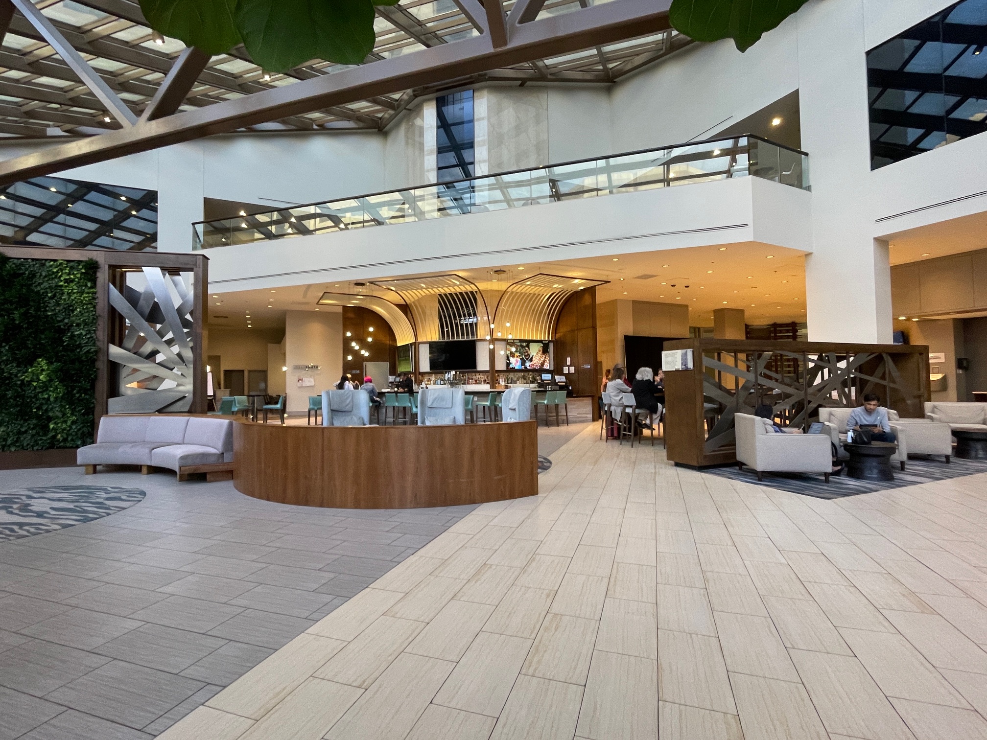 hotel lobby with multiple seating areas and bar